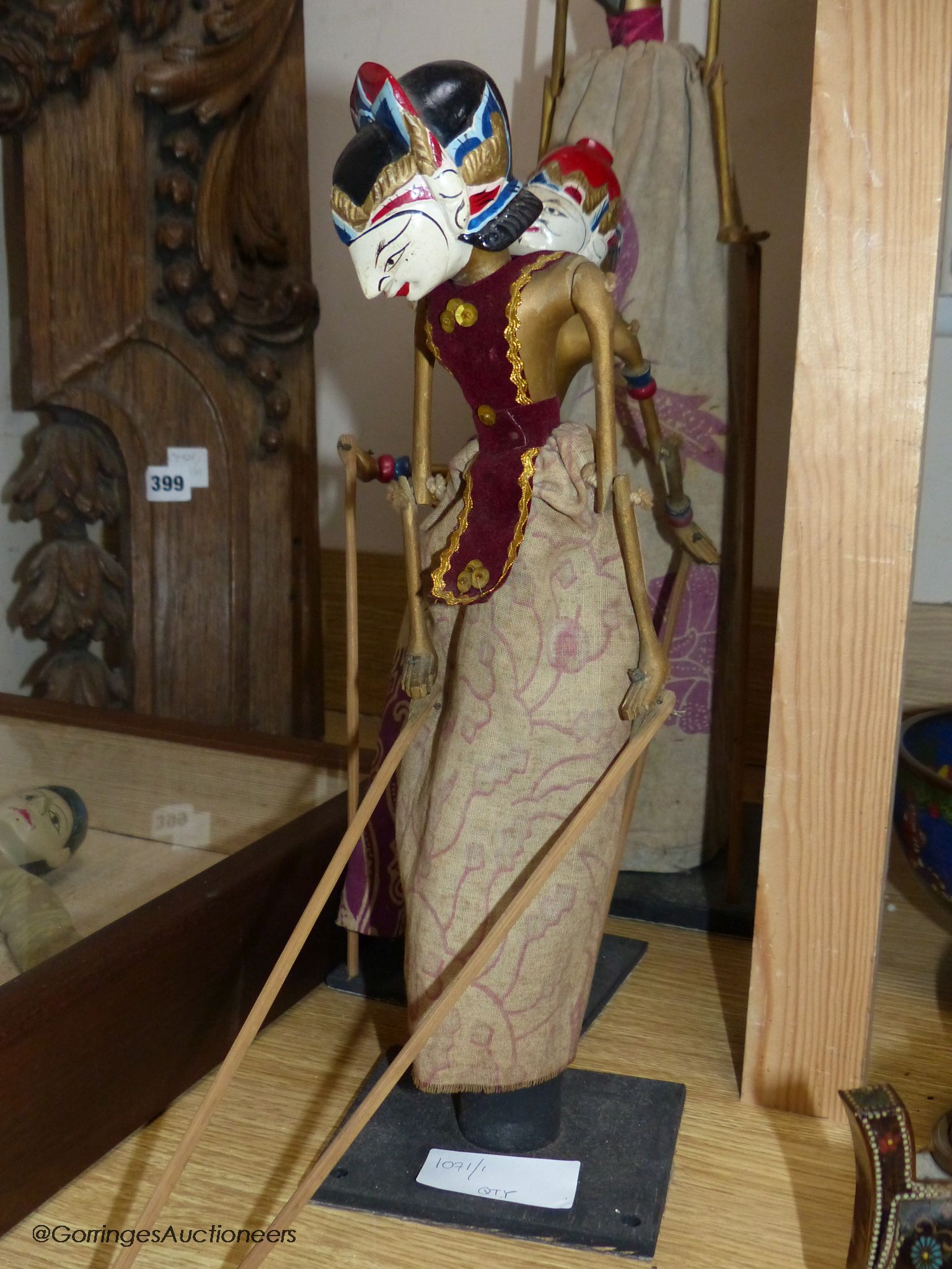 Three Indonesian stick puppets and another framed puppet, tallest 59cm